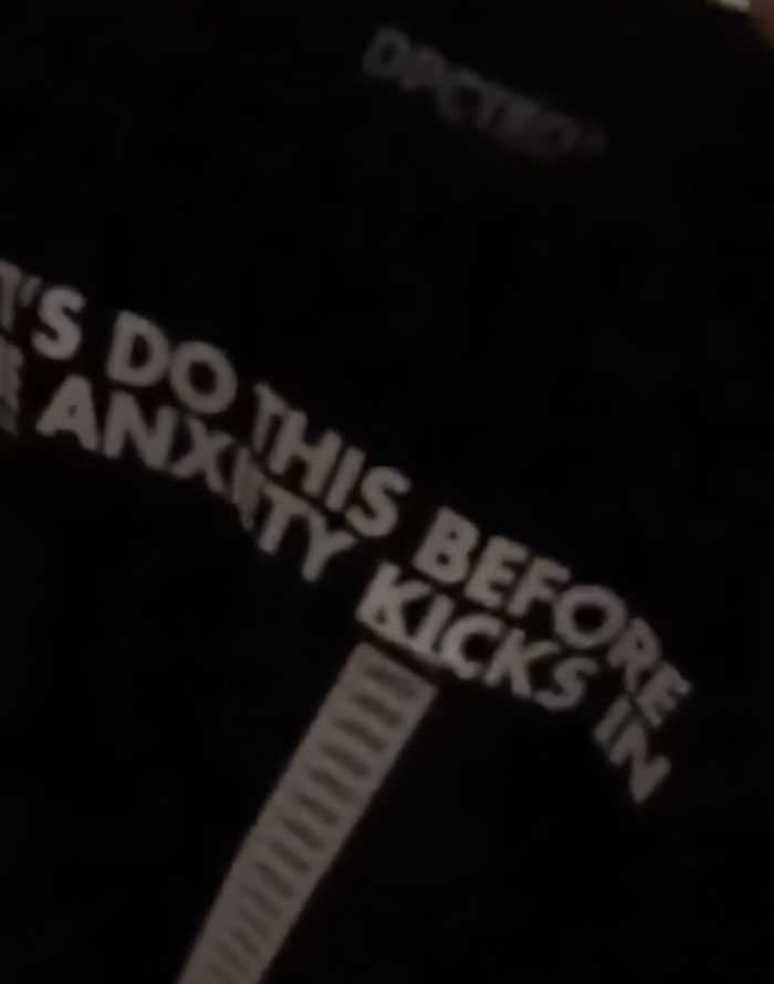Close-up of a dark shirt with bold text related to anxiety seen in disturbing Minneapolis massacre culprit manifesto photos. Close-up of a dark shirt with bold text related to anxiety seen in disturbing Minneapolis massacre culprit manifesto photos.