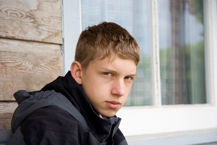 Teen boy with serious expression outdoors, reflecting tension around 14YO exploding at mom over black girlfriend dressing comfortably. Teen boy with serious expression outdoors, reflecting tension around 14YO exploding at mom over black girlfriend dressing comfortably.