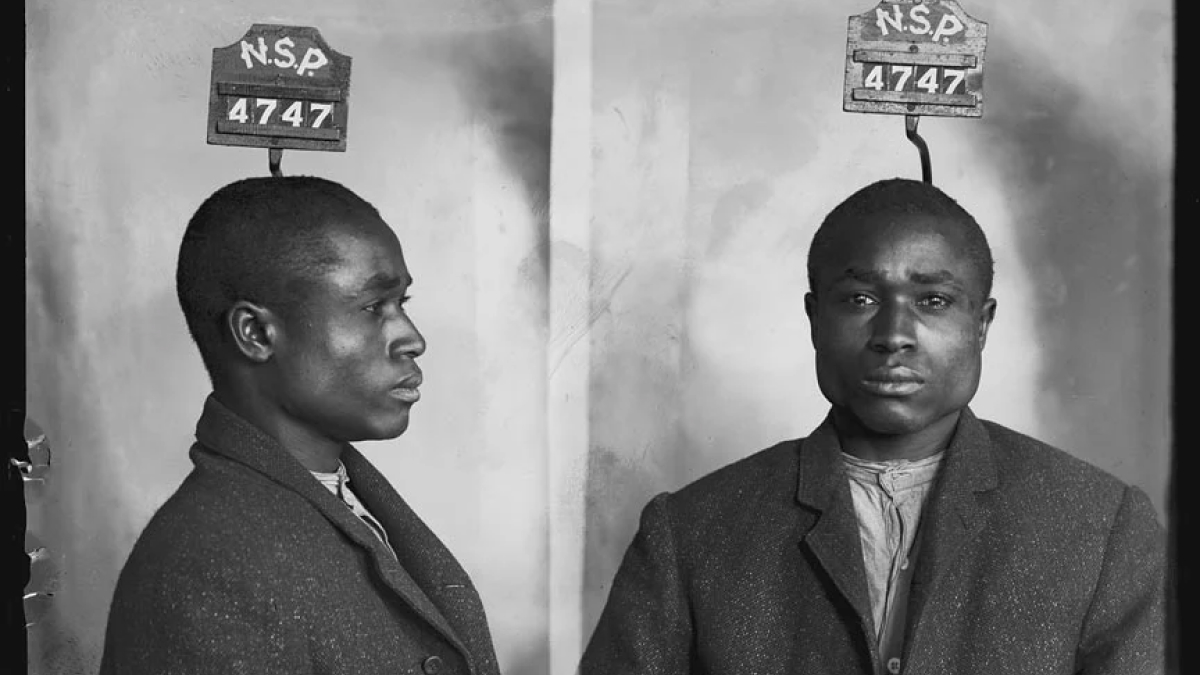 Black and white historical mugshot of a man with NSP 4747 ID, showing front and profile views.