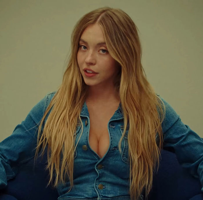 Young woman with long blonde hair wearing a denim jacket in an ad sparking woke outrage related to genetics debate. Young woman with long blonde hair wearing a denim jacket in an ad sparking woke outrage related to genetics debate.