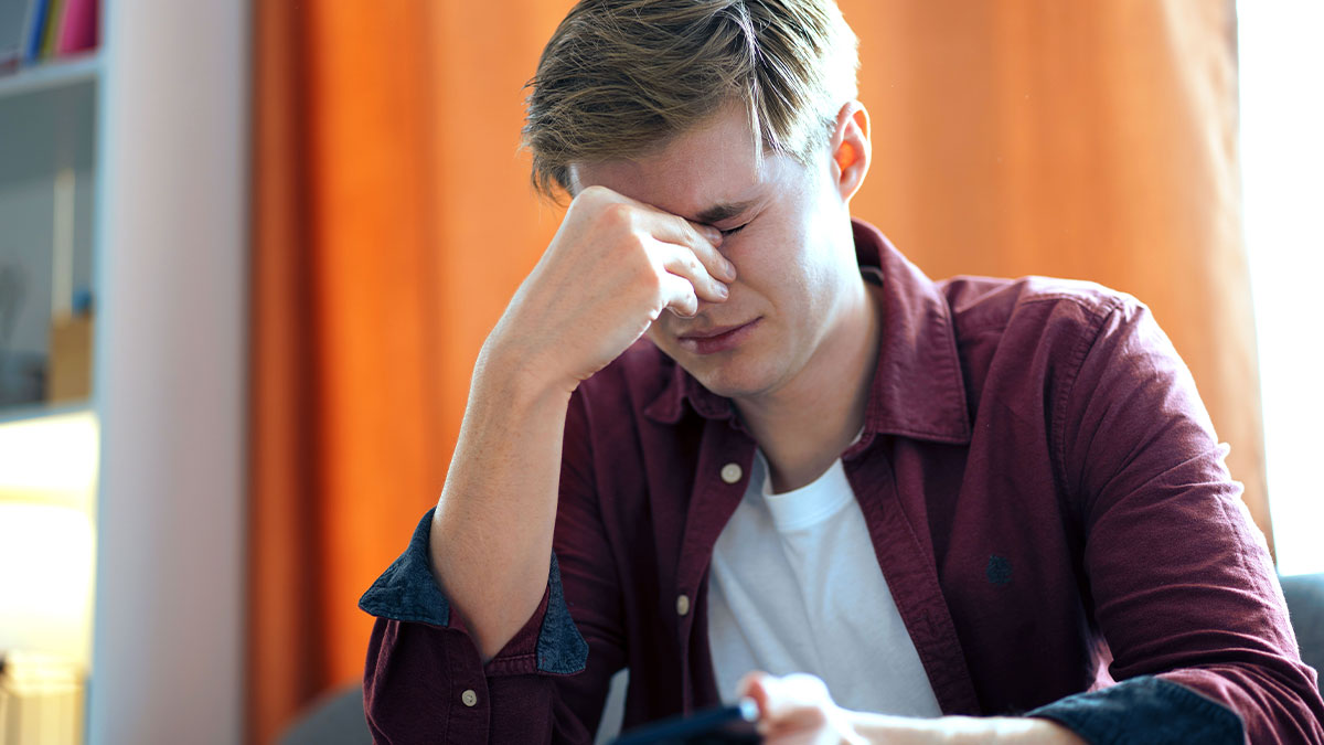 Teen frustrated and stressed at home, holding phone, reflecting on escaping dadu2019s babysitting trap and demands