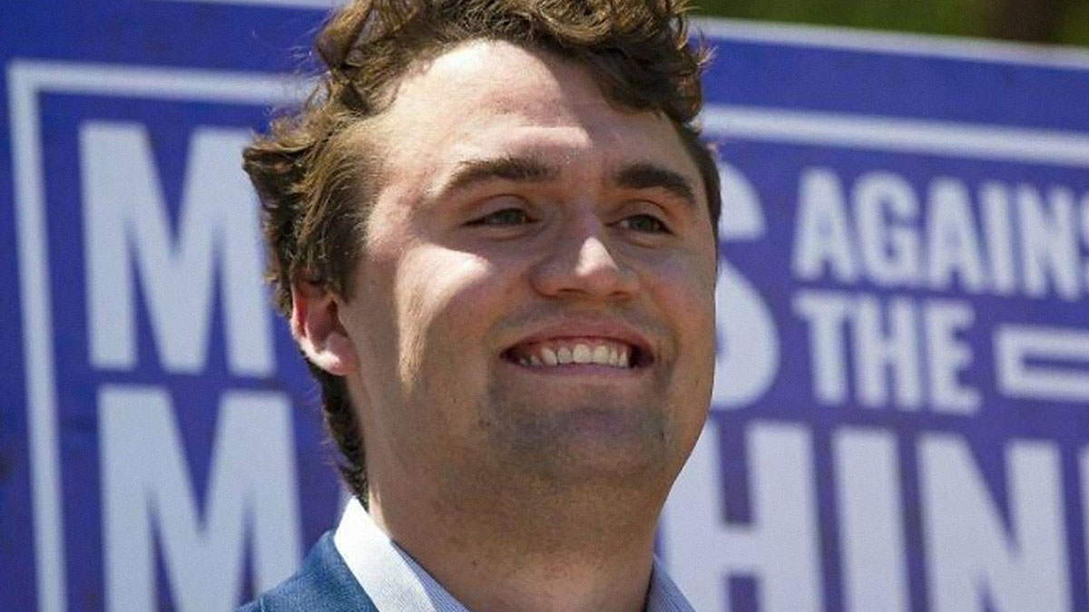 Young man smiling confidently at a public event, captured as a notable there was an attempt moment failed spectacularly.