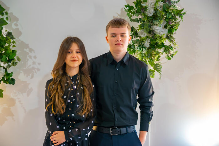 Teen boy and girl standing together indoors, evoking childhood memories that felt sweet but became unsettling in retrospect.