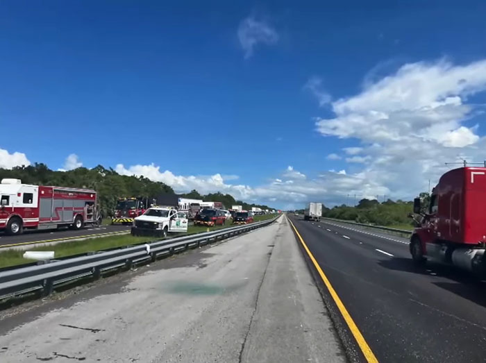 Emergency vehicles and a truck on a highway following a horrifying illegal U-turn accident involving a truck driver. Emergency vehicles and a truck on a highway following a horrifying illegal U-turn accident involving a truck driver.
