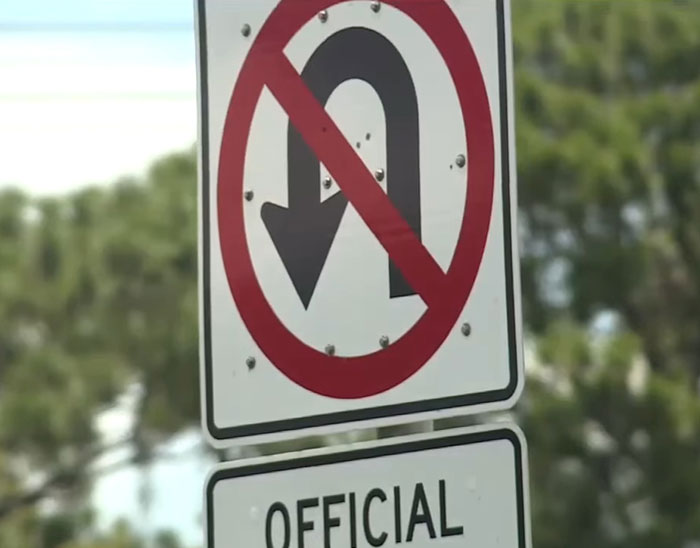 No U-turn traffic sign displayed on a pole, highlighting illegal truck driver maneuver risks and road safety. No U-turn traffic sign displayed on a pole, highlighting illegal truck driver maneuver risks and road safety.