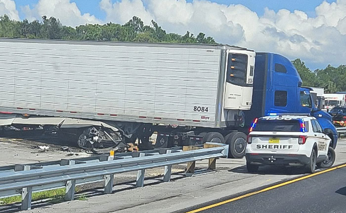 Truck involved in a fatal illegal U-turn accident with sheriff vehicle on highway shoulder during daylight. Truck involved in a fatal illegal U-turn accident with sheriff vehicle on highway shoulder during daylight.