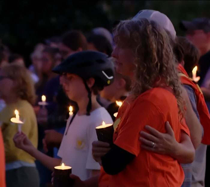 People holding candles at a vigil, reflecting concern over Minneapolis school attacker’s mother not cooperating with cops. People holding candles at a vigil, reflecting concern over Minneapolis school attacker’s mother not cooperating with cops.