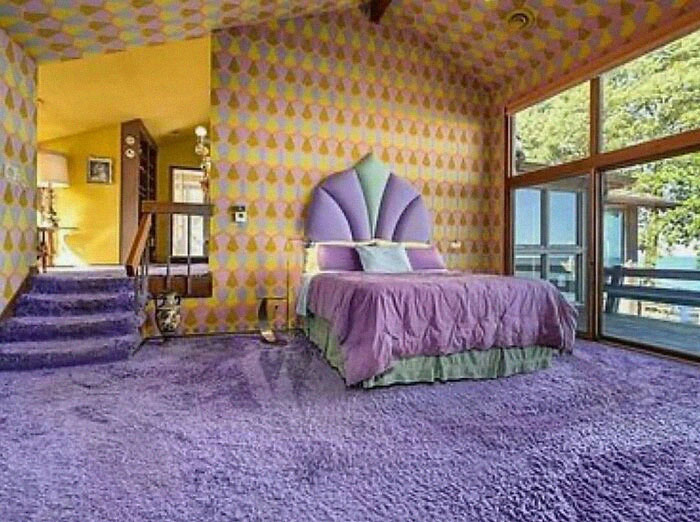 Vintage bedroom with purple carpet and retro patterned walls showing June Cleavers vintage closet style.