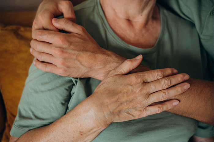 Close-up of a person in a green shirt showing self-comfort, reflecting real-life confessions water sign will recognize.