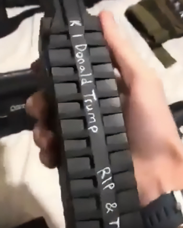 Hand holding a firearm magazine with disturbing writing linked to Minneapolis massacre culprit's manifesto and photos. Hand holding a firearm magazine with disturbing writing linked to Minneapolis massacre culprit's manifesto and photos.