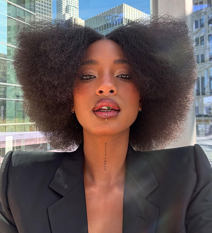 Will Smith and Jada Pinkett's daughter with natural afro hairstyle and piercings in an outdoor urban selfie. Will Smith and Jada Pinkett's daughter with natural afro hairstyle and piercings in an outdoor urban selfie.