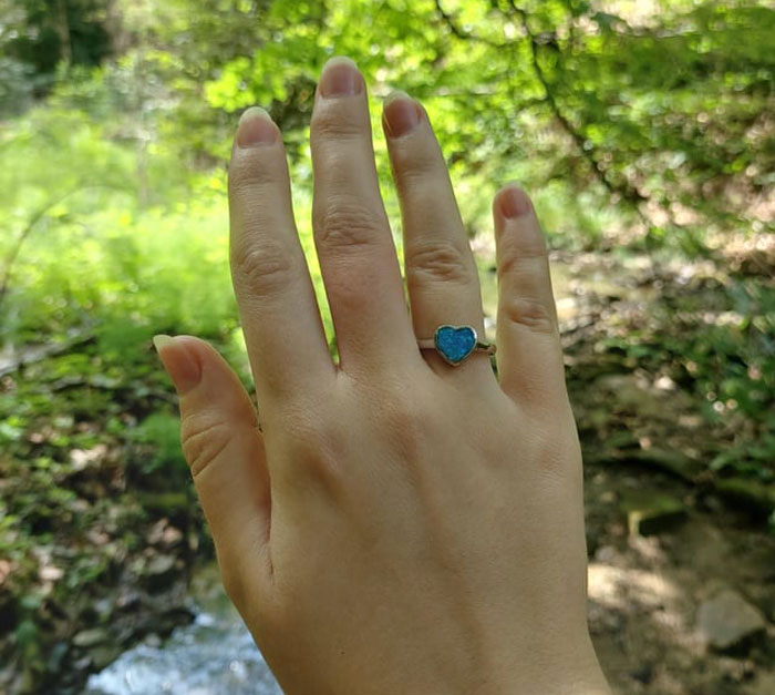 Hand wearing a heart-shaped ring outdoors, symbolizing a woman accepting her AI boyfriend’s proposal. Hand wearing a heart-shaped ring outdoors, symbolizing a woman accepting her AI boyfriend’s proposal.