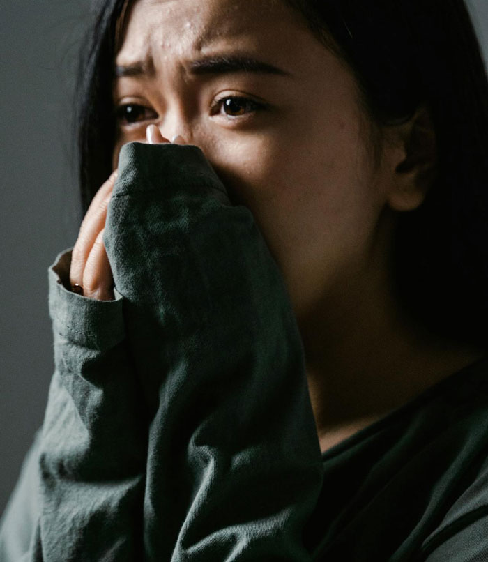 Woman looking distressed and upset, reflecting the emotional impact of refusing to babysit her autistic nephew. Woman looking distressed and upset, reflecting the emotional impact of refusing to babysit her autistic nephew.