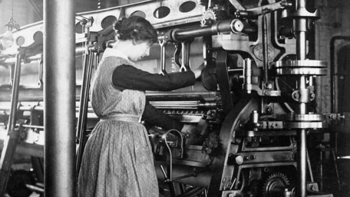 Woman operating heavy industrial machinery in a factory, illustrating how women changed everything during WWI.