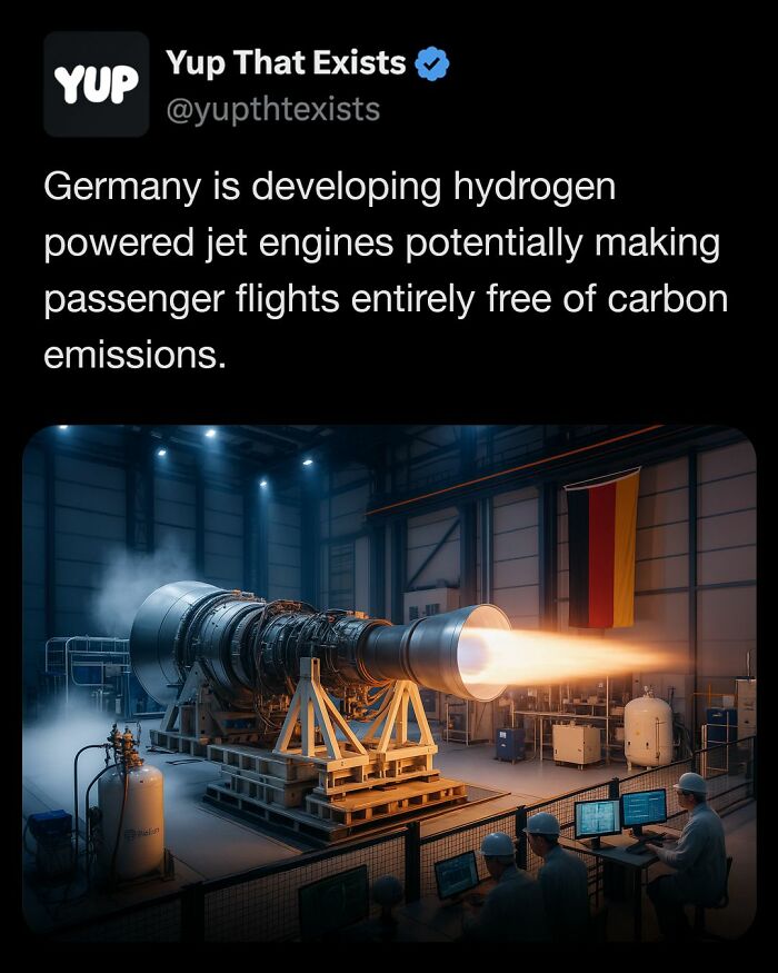 Hydrogen powered jet engine emitting flame inside industrial facility with engineers monitoring tests nearby.