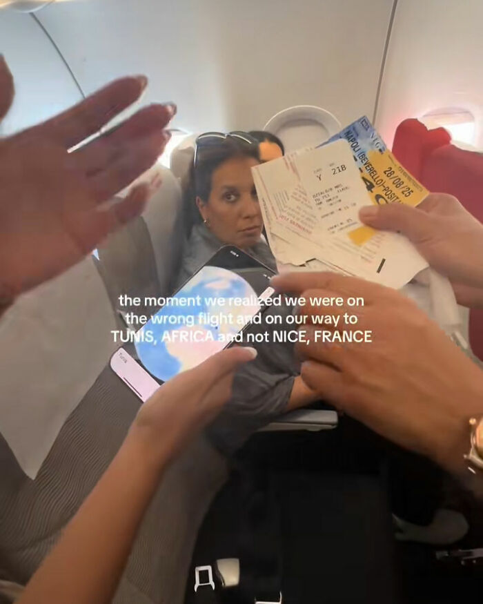 Tourists realize mid-flight they are headed to Africa instead of France, showing tickets and signs of confusion on plane. Tourists realize mid-flight they are headed to Africa instead of France, showing tickets and signs of confusion on plane.