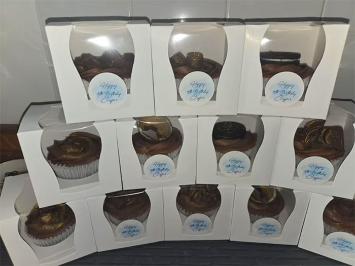 Chocolate cupcakes baked by mom for son’s birthday, each boxed with a Happy Birthday label, showcasing school’s unexpected reaction. Chocolate cupcakes baked by mom for son’s birthday, each boxed with a Happy Birthday label, showcasing school’s unexpected reaction.