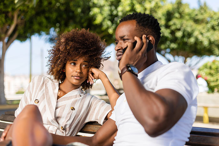 Man and woman sitting on park bench outdoors, reflecting on mountain biking meltdown early in the morning. Man and woman sitting on park bench outdoors, reflecting on mountain biking meltdown early in the morning.