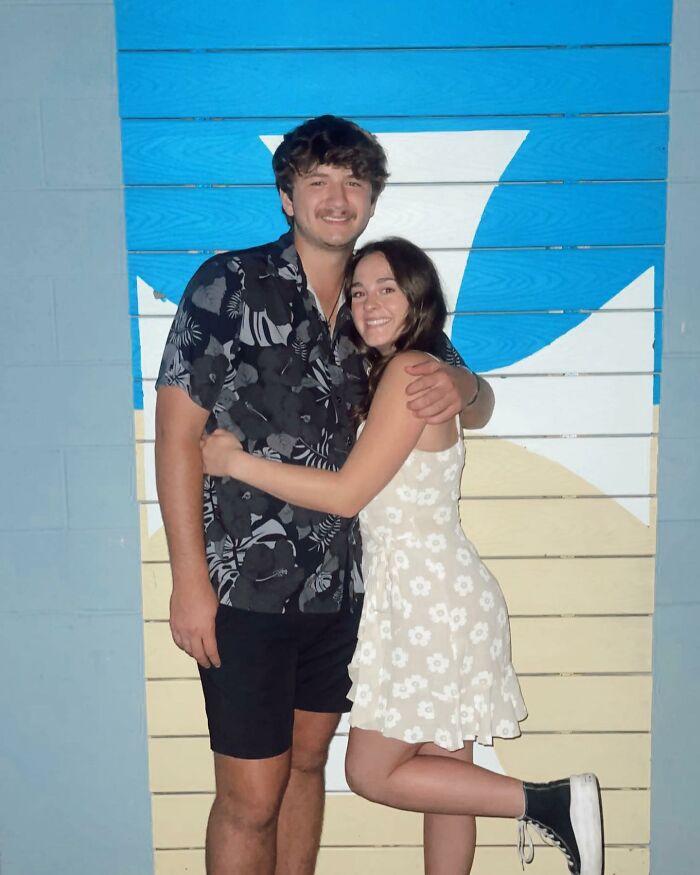 Young couple posing in front of a blue and beige wall, unrelated to Bryan Kohberger's mom discussing Idaho crimes. Young couple posing in front of a blue and beige wall, unrelated to Bryan Kohberger's mom discussing Idaho crimes.