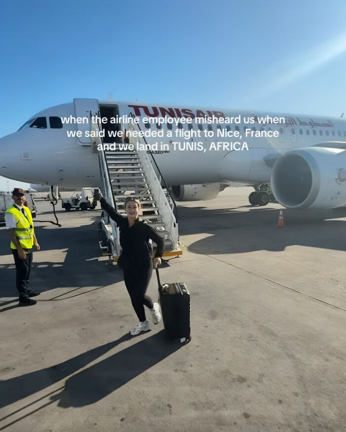 Tourist with luggage on tarmac near plane, highlighting confused tourists boarding flight to Africa instead of France. Tourist with luggage on tarmac near plane, highlighting confused tourists boarding flight to Africa instead of France.