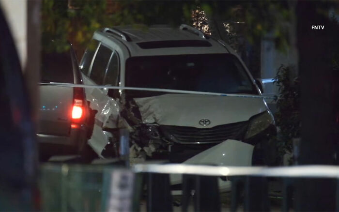 Damaged white Toyota SUV behind police tape at night scene related to maniac driver incident after hitting teen.
