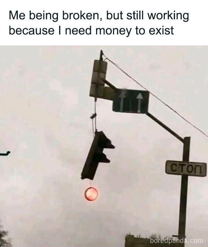 Traffic light hanging broken with one red light on, illustrating millennial struggles at work and daily grind.