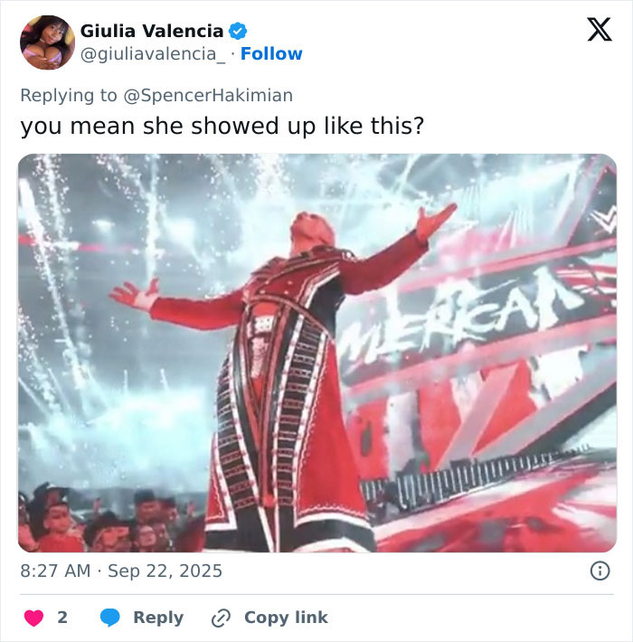 Male WWE wrestler in red costume with arms outstretched amid fireworks during a dramatic entrance at event. Male WWE wrestler in red costume with arms outstretched amid fireworks during a dramatic entrance at event.