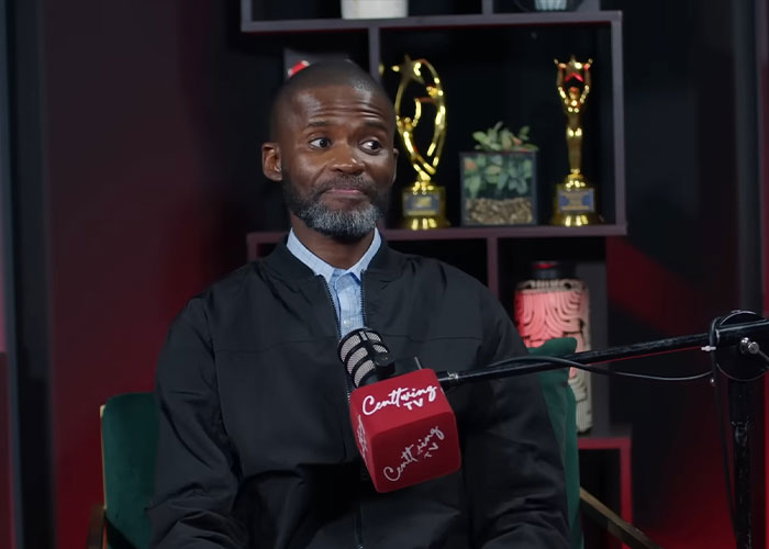 Man hosting a podcast with a red microphone, reacting emotionally to a RaptureTok viral prediction on camera. Man hosting a podcast with a red microphone, reacting emotionally to a RaptureTok viral prediction on camera.