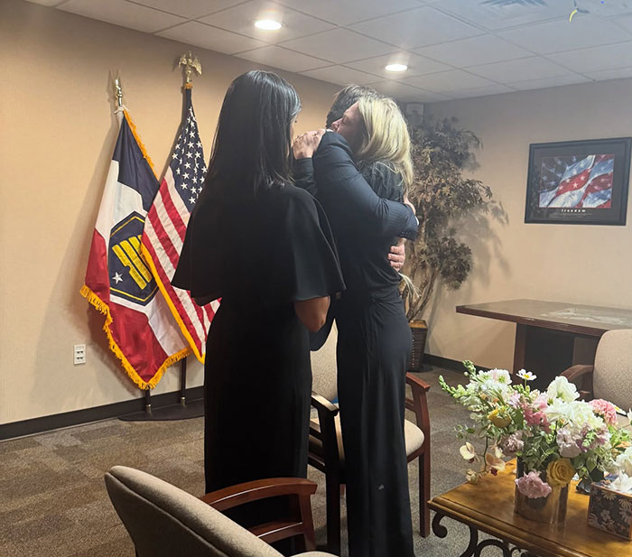 Two women embracing in an office with American flags, symbolizing FBI revealing chilling note and DNA evidence links. Two women embracing in an office with American flags, symbolizing FBI revealing chilling note and DNA evidence links.