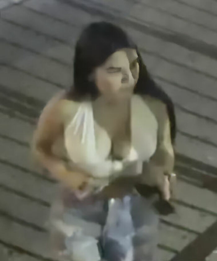 Woman in white top with long dark hair walking on a wooden surface, related to maniac driver shocking response to cops case.