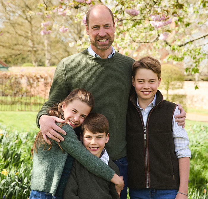 Prince William with his three children outdoors in a garden, showing family affection after royal funeral moments. Prince William with his three children outdoors in a garden, showing family affection after royal funeral moments.