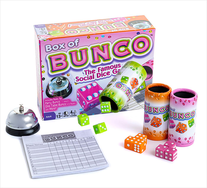 Box of Bunco dice game set with colorful dice, cups, bell, and score sheet linked to Brooklyn midwife safety concerns.