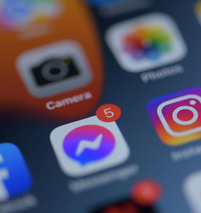 Close-up of a phone screen showing app icons and notifications impacting feelings and the ick from a single glance at a phone.