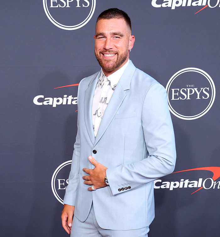 Travis Kelce in a light blue suit smiling on the red carpet, related to his answer about Taylor Swift in a viral video. Travis Kelce in a light blue suit smiling on the red carpet, related to his answer about Taylor Swift in a viral video.