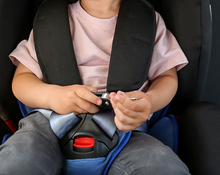Toddler secured in a car seat, highlighting concerns about a couple arrested for hotboxing with a 2-year-old in the backseat. Toddler secured in a car seat, highlighting concerns about a couple arrested for hotboxing with a 2-year-old in the backseat.
