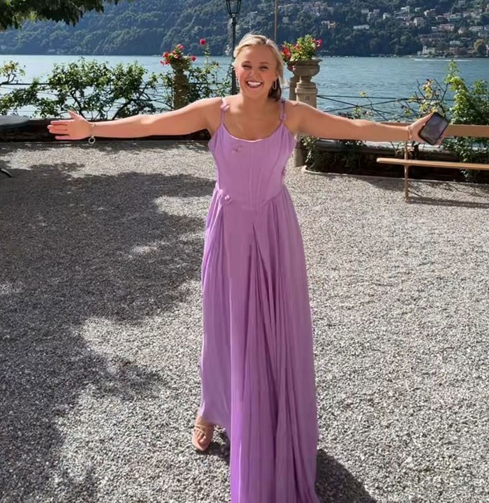 JoJo Siwa smiling outdoors in a purple dress, embracing fans after sharing her marriage plans and gold mini dress look. JoJo Siwa smiling outdoors in a purple dress, embracing fans after sharing her marriage plans and gold mini dress look.