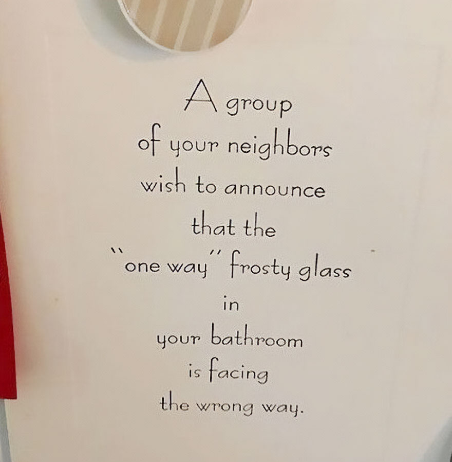 Humorous wall text about neighbors and a one way frosty glass in a bathroom, perfect for living in the middle of nowhere.