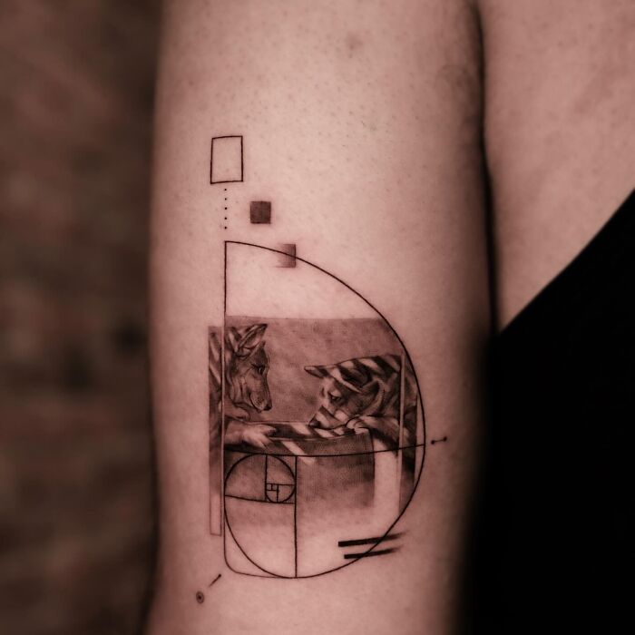 Geometric black and gray pet tattoo of two dogs on inner arm by Korean tattoo artist specializing in emotional pet tattoos.