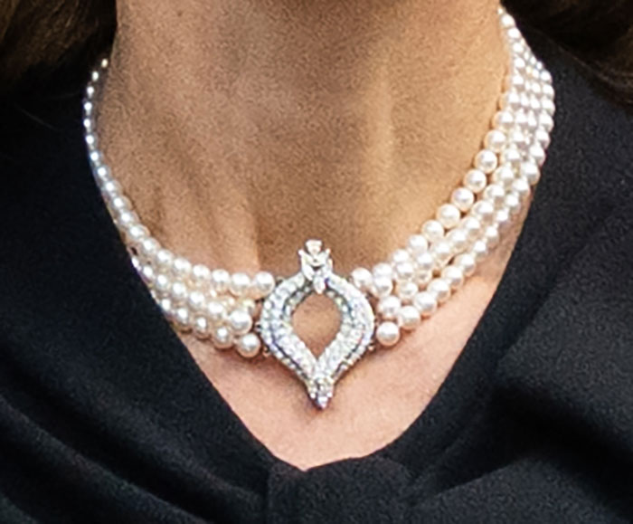 Close-up of elegant pearl necklace worn by Kate Middleton after royal funeral, symbolizing farewell to King Charles. Close-up of elegant pearl necklace worn by Kate Middleton after royal funeral, symbolizing farewell to King Charles.
