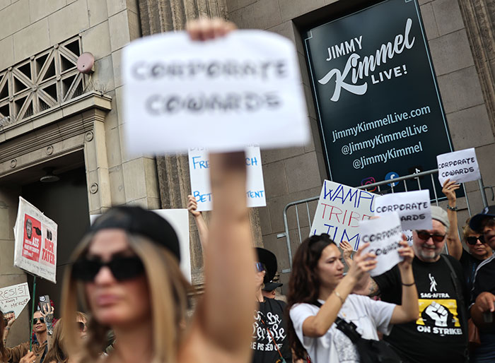 Protesters holding signs outside Jimmy Kimmel Live venue amid discussions on Jimmy Kimmel's show suspension. Protesters holding signs outside Jimmy Kimmel Live venue amid discussions on Jimmy Kimmel's show suspension.