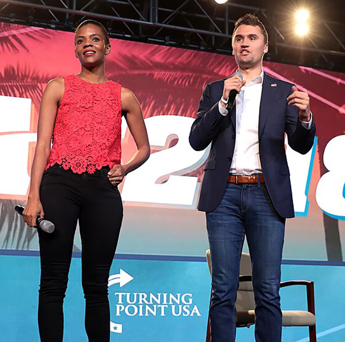 Candace Owens and Charlie Kirk speaking on stage at a Turning Point USA event with a vibrant backdrop. Candace Owens and Charlie Kirk speaking on stage at a Turning Point USA event with a vibrant backdrop.