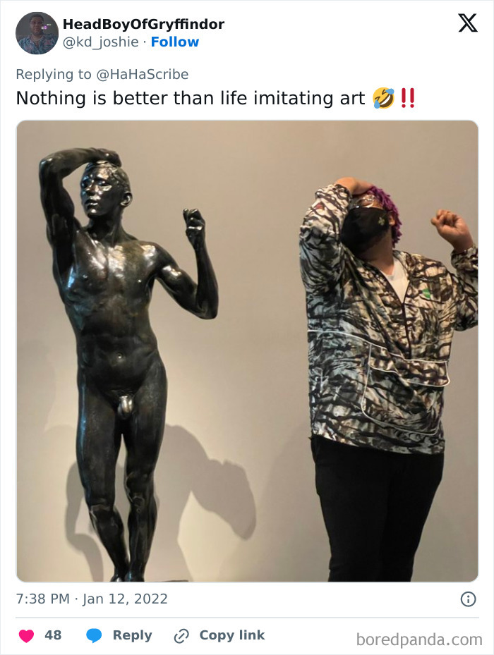 Person imitating iconic art statue pose indoors, showcasing creative and hilarious art imitation in a museum setting.