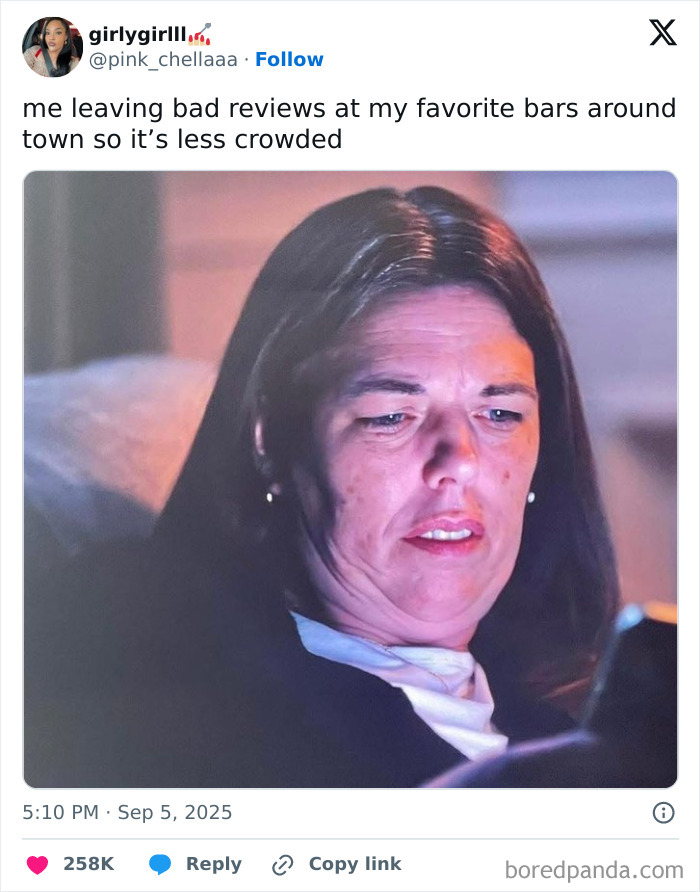 Woman looking at phone with a focused expression, featured in funniest tweets of September compilation.