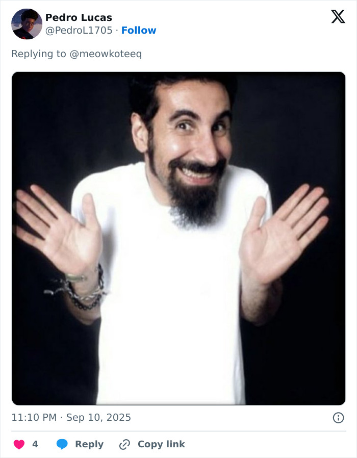 Man with beard and dark hair in white shirt smiling and raising hands, related to J.K. Rowling team cancer rumor response. Man with beard and dark hair in white shirt smiling and raising hands, related to J.K. Rowling team cancer rumor response.