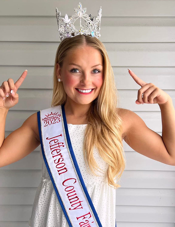 Cheerleader wearing crown and sash at Jefferson County Fair 2023, unrelated to autopsy findings of newborn gender. Cheerleader wearing crown and sash at Jefferson County Fair 2023, unrelated to autopsy findings of newborn gender.