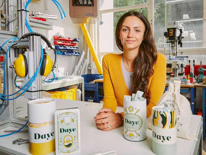 Woman in a yellow sweater in a workshop showcasing Daye products related to hair and teeth growth inside a 9-year-old girl. Woman in a yellow sweater in a workshop showcasing Daye products related to hair and teeth growth inside a 9-year-old girl.