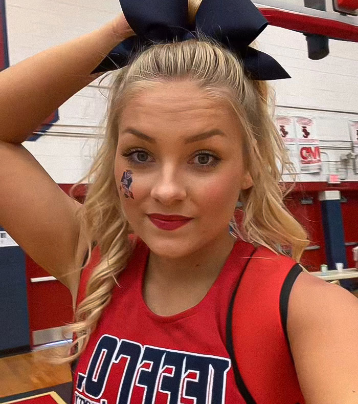 Cheerleader wearing a red uniform with bow in gym, related to newborn found stuffed in her closet and university dropout. Cheerleader wearing a red uniform with bow in gym, related to newborn found stuffed in her closet and university dropout.