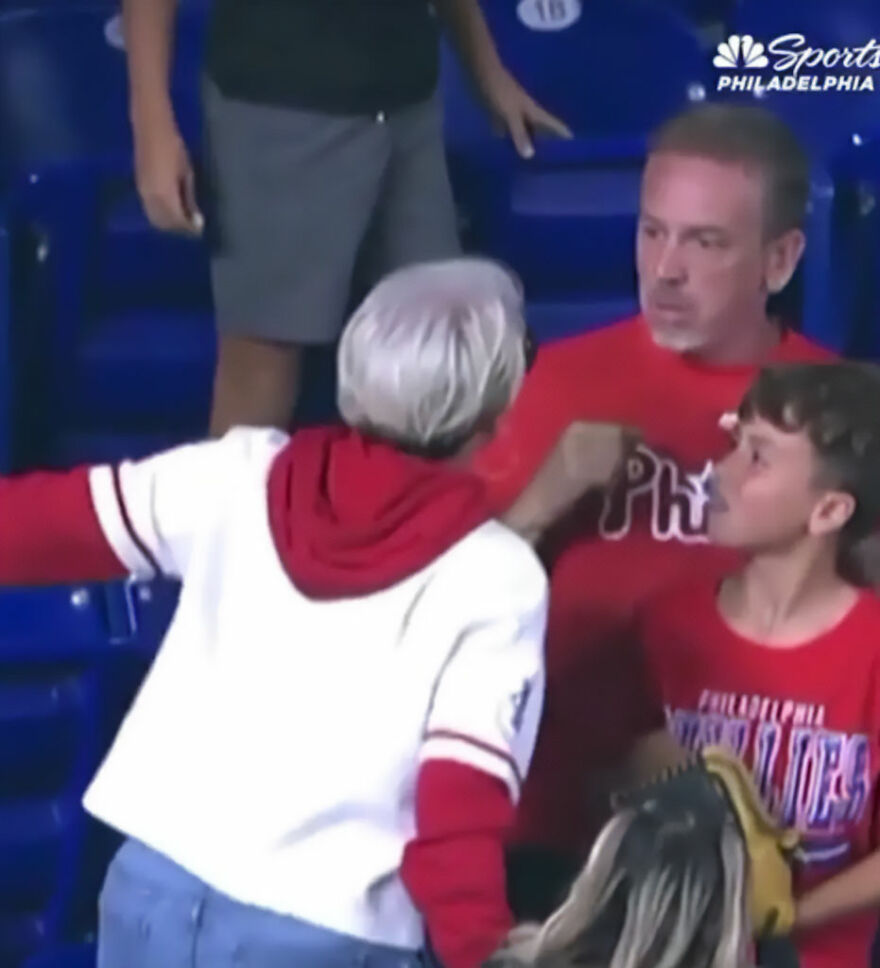 Woman wearing Phillies gear in a confrontation during a home run ball meltdown at a Philadelphia Phillies game. Woman wearing Phillies gear in a confrontation during a home run ball meltdown at a Philadelphia Phillies game.