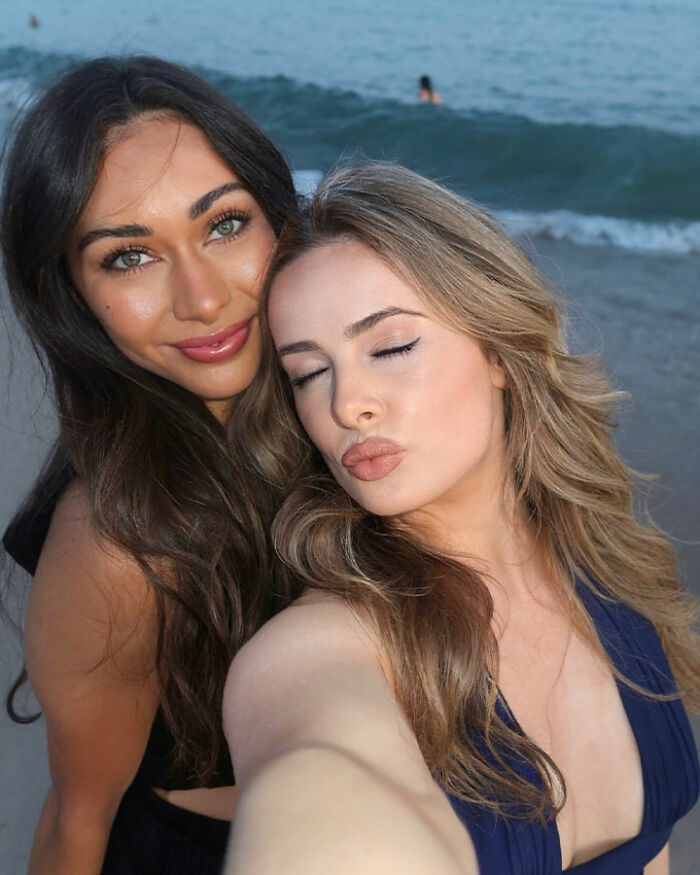 Two tourists taking a selfie on the beach, representing confused tourists boarding a flight to Africa instead of France. Two tourists taking a selfie on the beach, representing confused tourists boarding a flight to Africa instead of France.