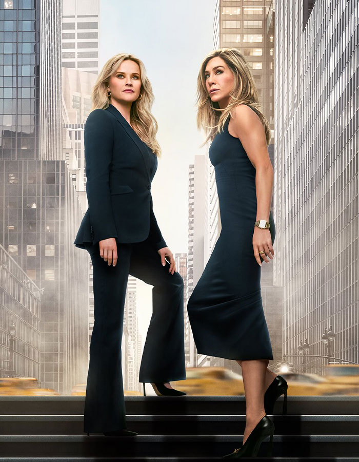 Jennifer Aniston and Reese Witherspoon standing in cityscape, highlighting friendship and surprise discovery moment. Jennifer Aniston and Reese Witherspoon standing in cityscape, highlighting friendship and surprise discovery moment.